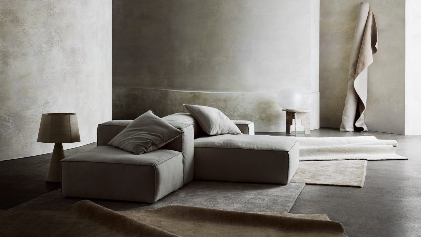 Photograph showing cool-toned living room with multiple rugs