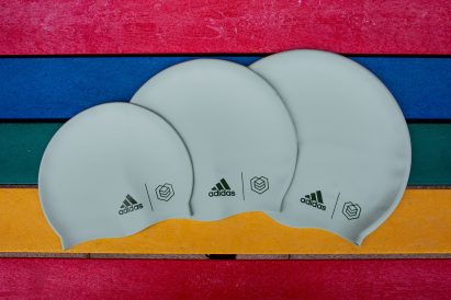 Three green swimming caps by Adidas and Soul Cap