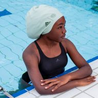 A girl wearing a Soul Cap swimming hat