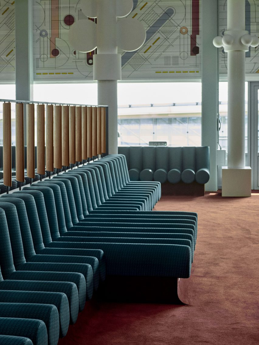 Photograph showing airport departure lounge with green bench seats