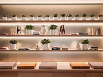 A wall with small potted plants and a bench