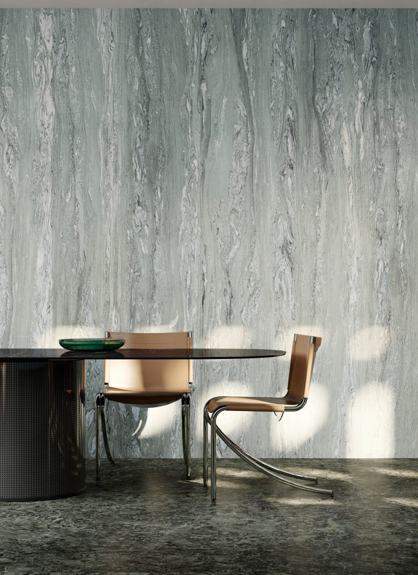 Photograph showing dining chairs and table with marble patterned wall behind