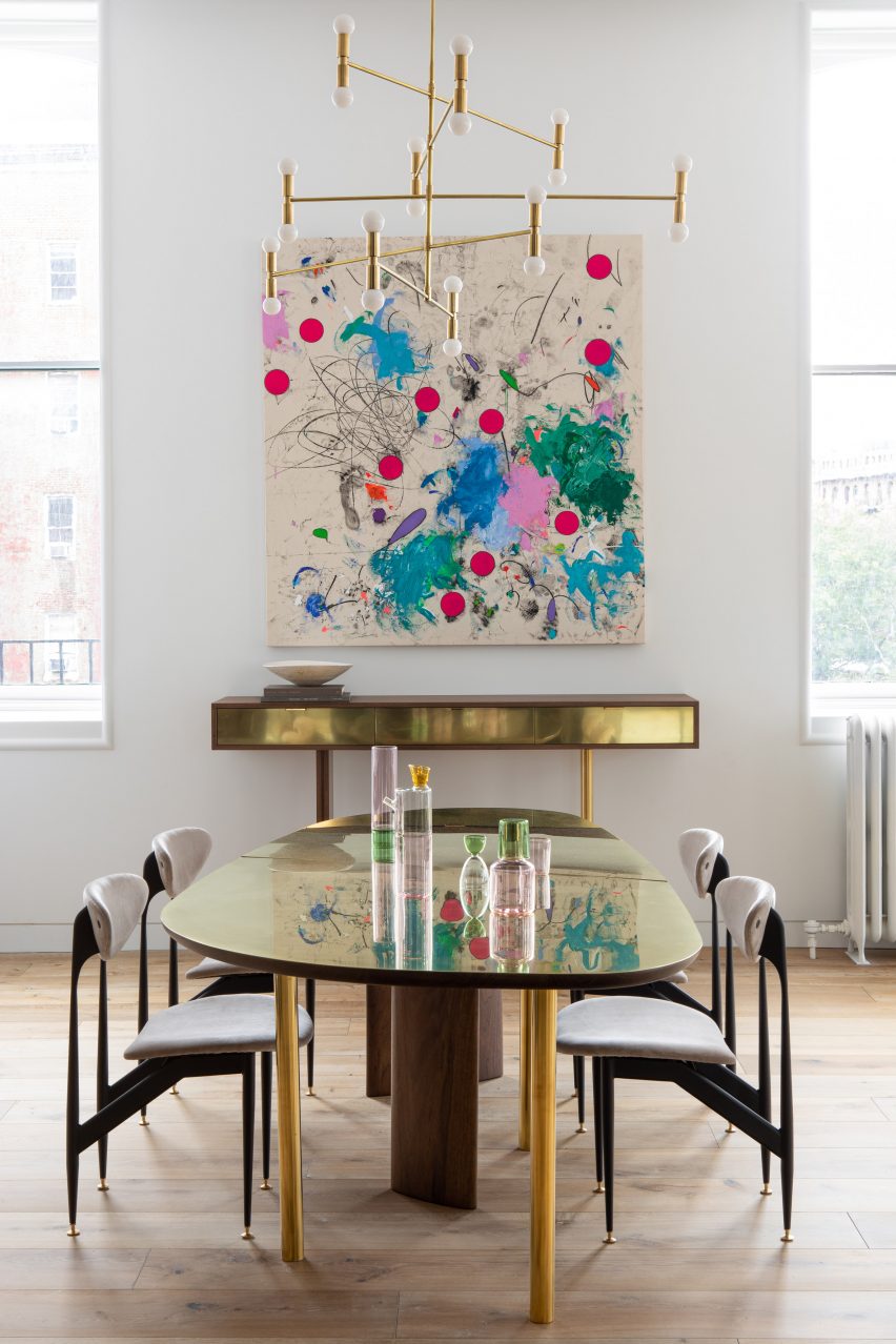 Dining room with custom brass and walnut furniture