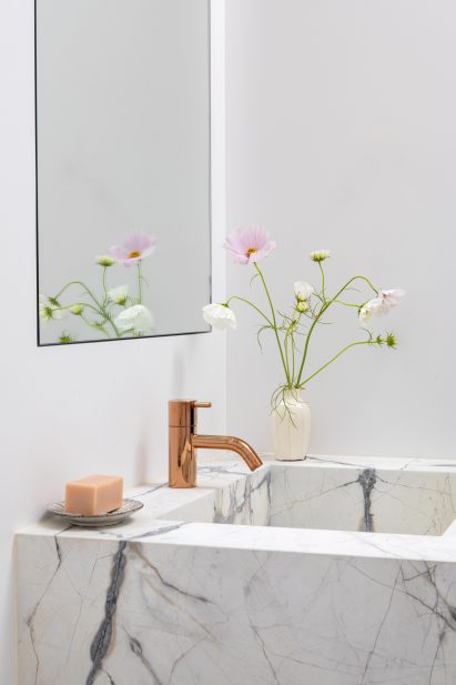 Guest bathroom featured bright metallic accents
