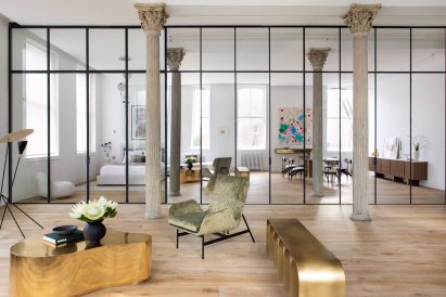 Living room with mirrored wall and detailed columns