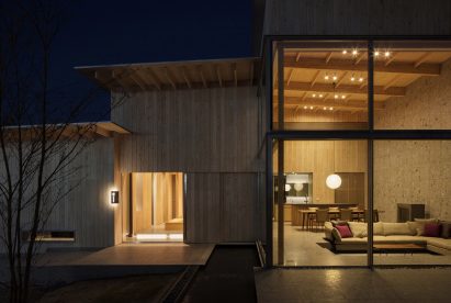 Double-height living area through floor-to-ceiling glass window in Japanese house