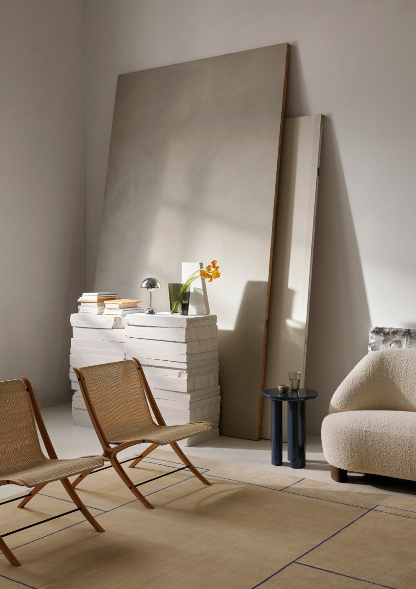 Photograph showing rattan and wooden chair by side table with lamp