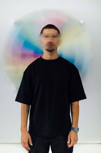 Pantone in front of his colourful artwork