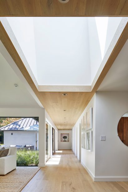 An open plan interior featuring wooden walls and flooring