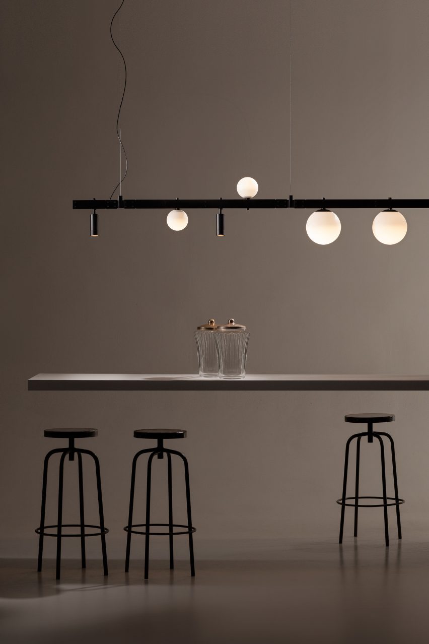 Track lighting installed above bar
