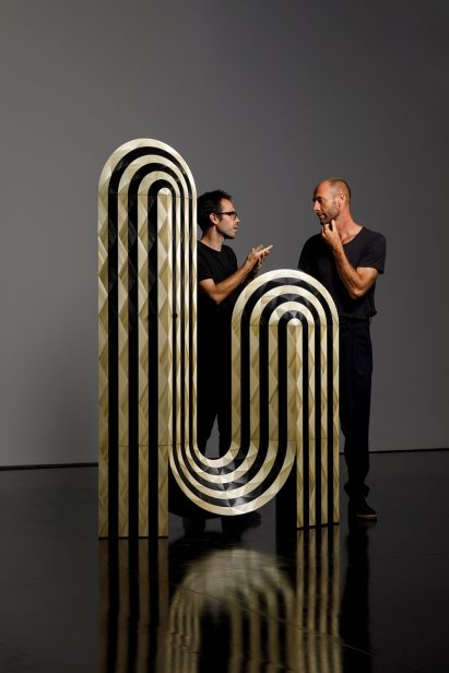 Asymmetric cabinet with figures