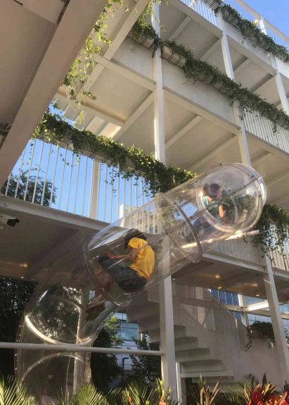 Image of a person in a transparent slide at the public park