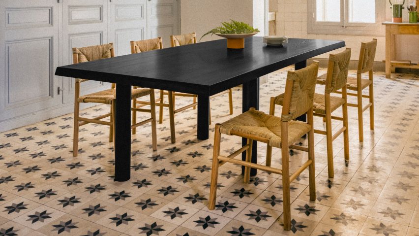 Photograph showing chairs round table in rustic interior with tiled floor