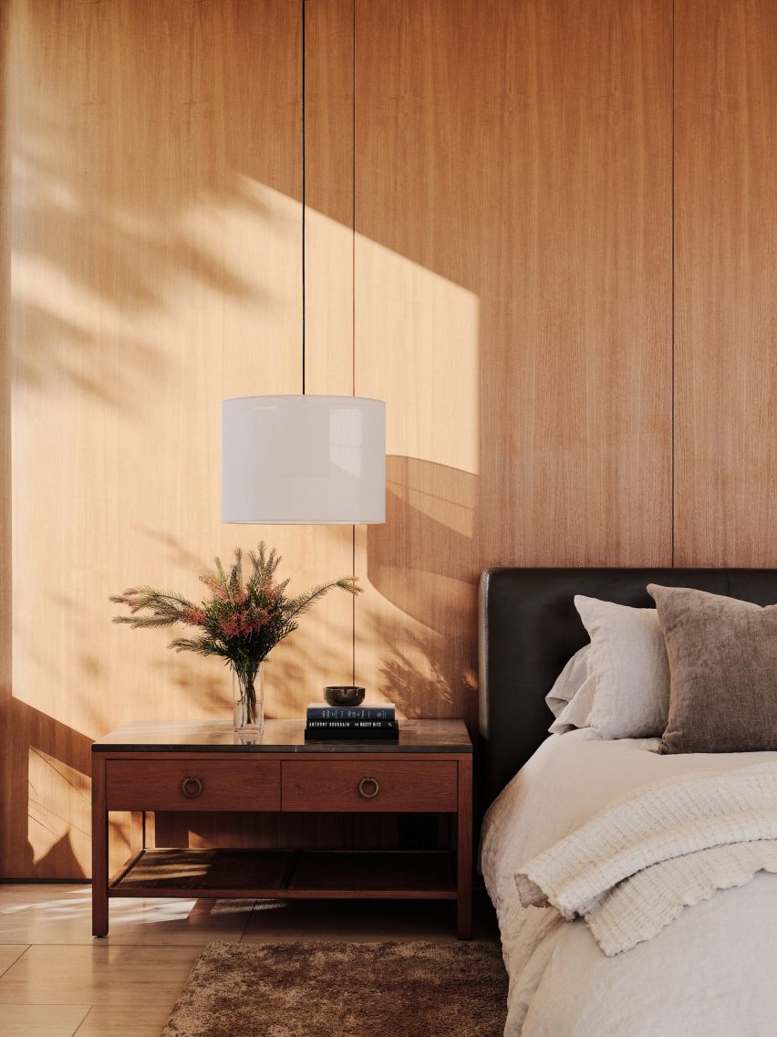 Teak-panelled bedroom in Clear Oak Residence by Woods + Dangaran