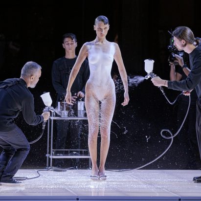 Fabrican is pictured spraying a dress onto a model
