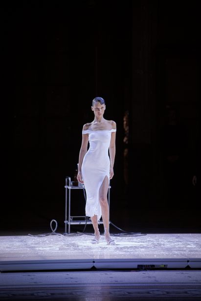 Bella Hadid is pictured wearing a white slip dress