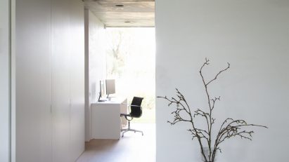 White Emura unit by Daikin in a hall with a small table