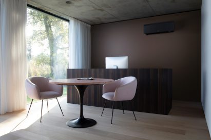 Black air conditioning unit by Daikin in a dark dining room
