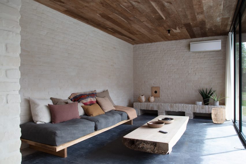 White Emura indoor climate control unit by Daikin in a living room with white walls and dark carpet