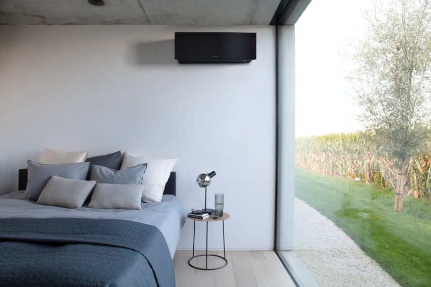 Black air conditioning unit by Daikin in a bedroom
