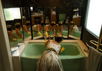 A woman cleaning a bathroom