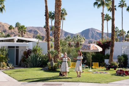 Two characters on a film set on grass lawns