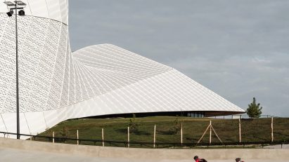 Cyclists in front of aluminium sports centre
