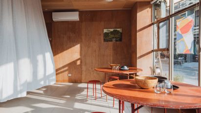 Red tables and chairs in F.Forest Office community centre in Taiwan by Atelier Boter
