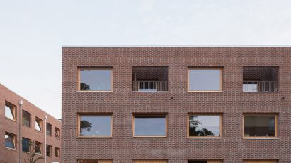 Exterior image of the red brick townhouses from street level that were designed by Forstberg Ling