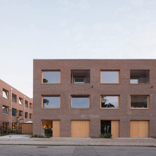 Exterior image of the red brick townhouses from street level that were designed by Forstberg Ling