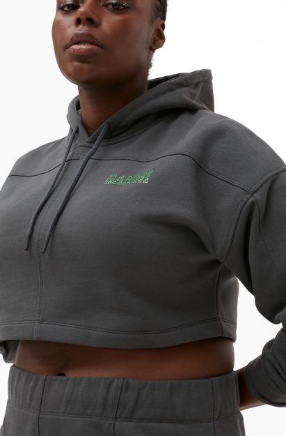 A woman wearing a dark grey Ganni hoody