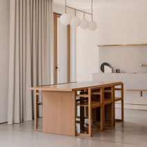 Wooden dining table and matching chairs in The Hideaway Home, Gdańsk, by ACOS