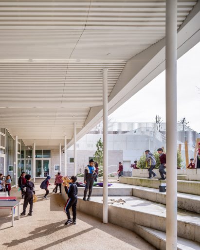 Image of children playing beneath a white zigzagging canopy at Edith Neville Primary School