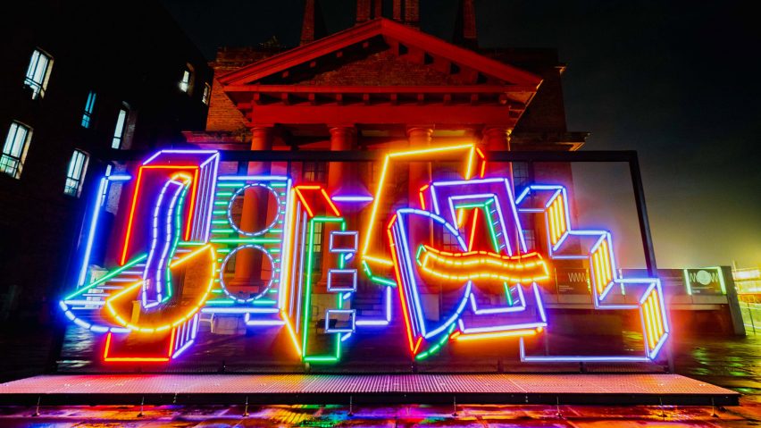 River Of Light colourful light installation by Camille Walala in front of a building at the Royal Albert Docks