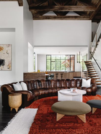 Leather sofa atop red rugs