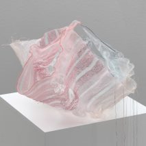 Blue and pink Sh(r)ine textile container by Iben Høj on a pedestal
