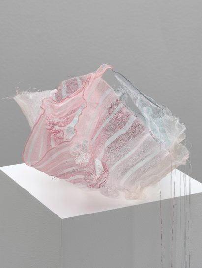 Blue and pink Sh(r)ine textile container by Iben Høj on a pedestal