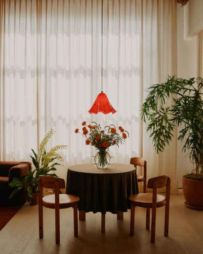 Pendant lamp above small table and chairs