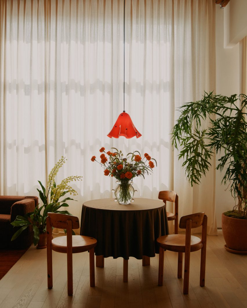 Pendant lamp above small table and chairs