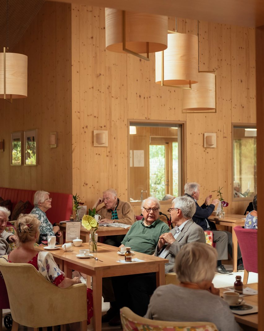 Residents in cafe at John Morden Centre by Mae Architects
