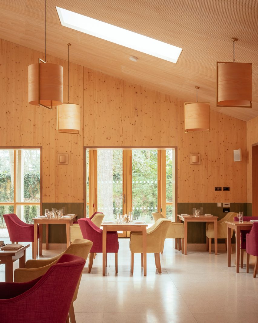 Timber-lined dining room in John Morden Centre by Mae Architects