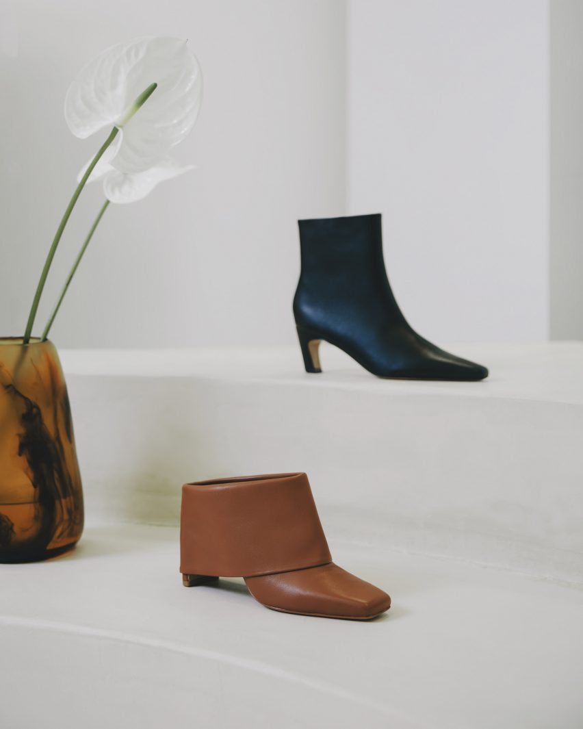 Shoes displayed beside flowers