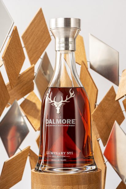 A whiskey bottle inside a wooden sculpture