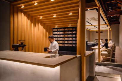 Barista working at coffee bar with staggered timber frame