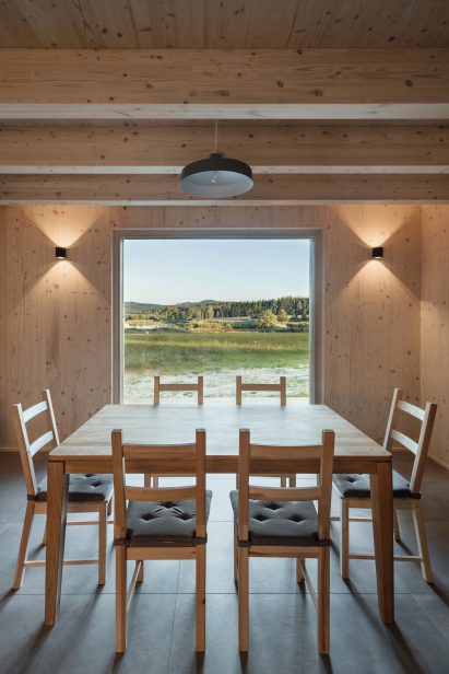 Interior image of the timber-lined dining area at Lipno Lakeside Cabin and its lakeside views