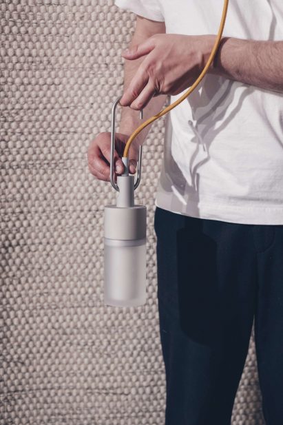 Person holding Lykta solar light by Lund University at Dutch Design Week