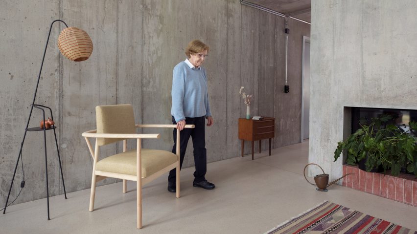 Elderly woman beside Lotte armchair