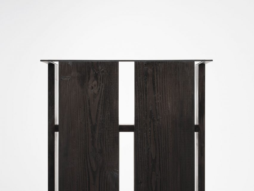 Detail of black chair on white plinth in front of white background