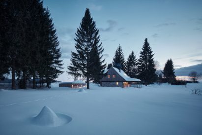 Photograph of cabin in snow