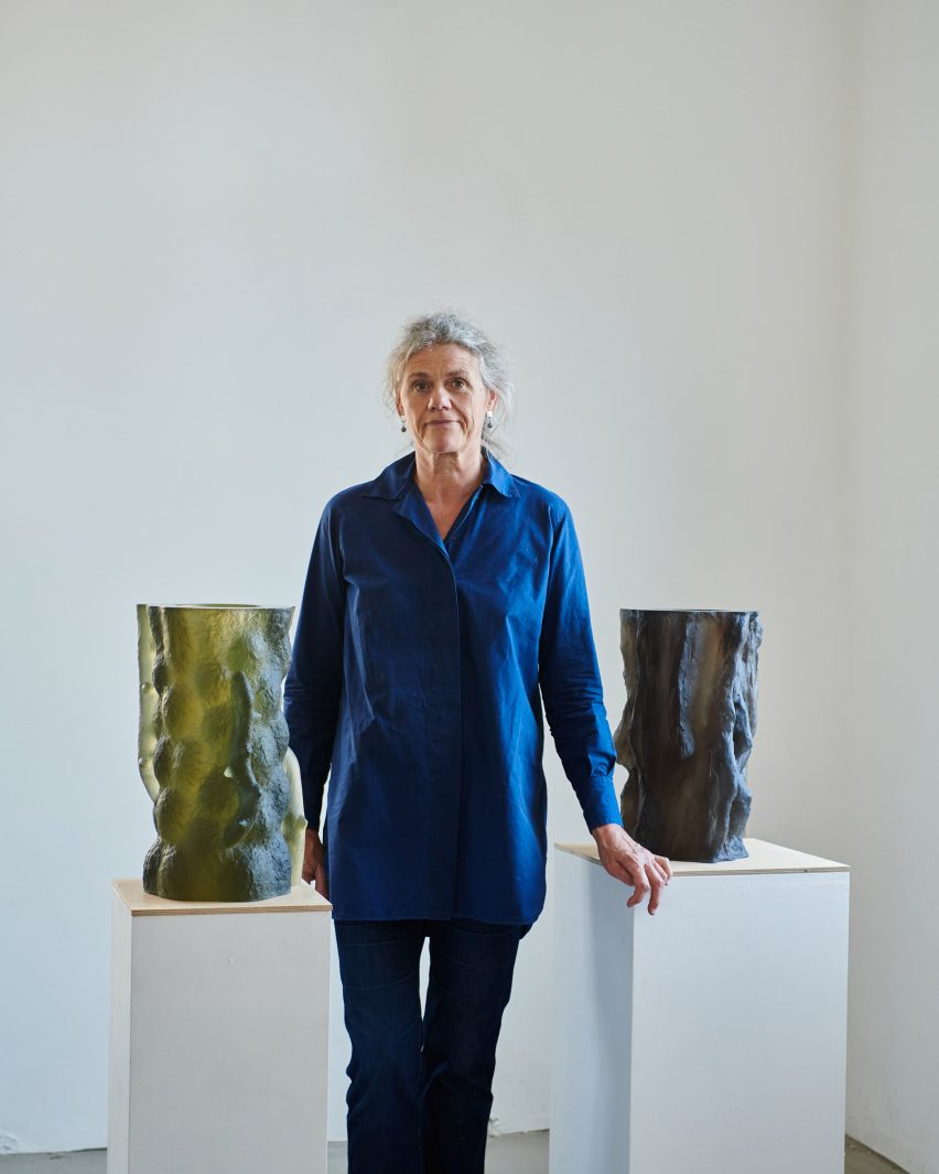 Photograph of artist with sculptures